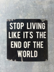 Sticker on a post in Omaha, Nebraska, that reads "Stop living like it's the end of the world"